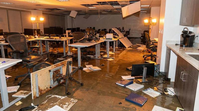 Flooded commercial office interior with standing water in Texas