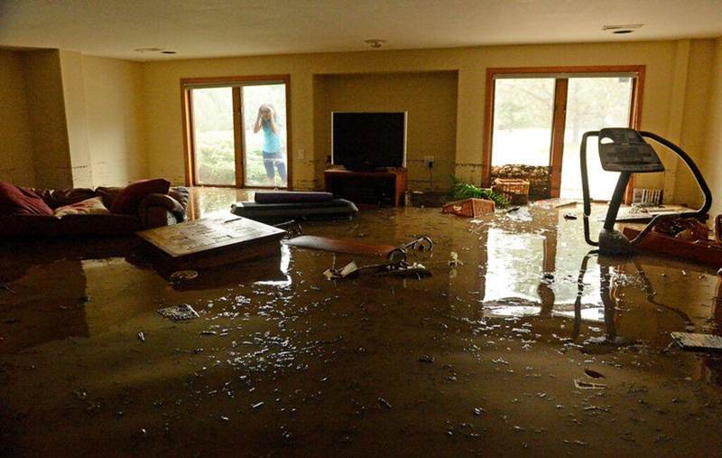 Flooded Texas living room with standing water covering the floor