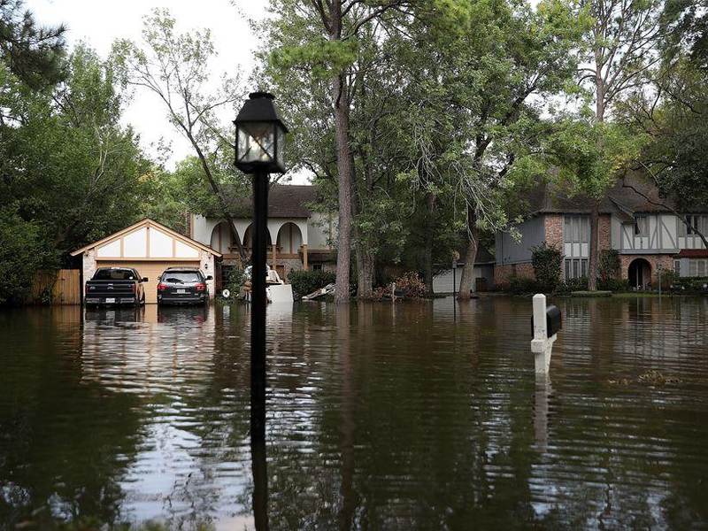 Flooded residential street in Houston Texas with houses in floodwater